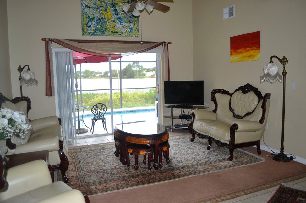 Spacious living room with fine art and lanai access